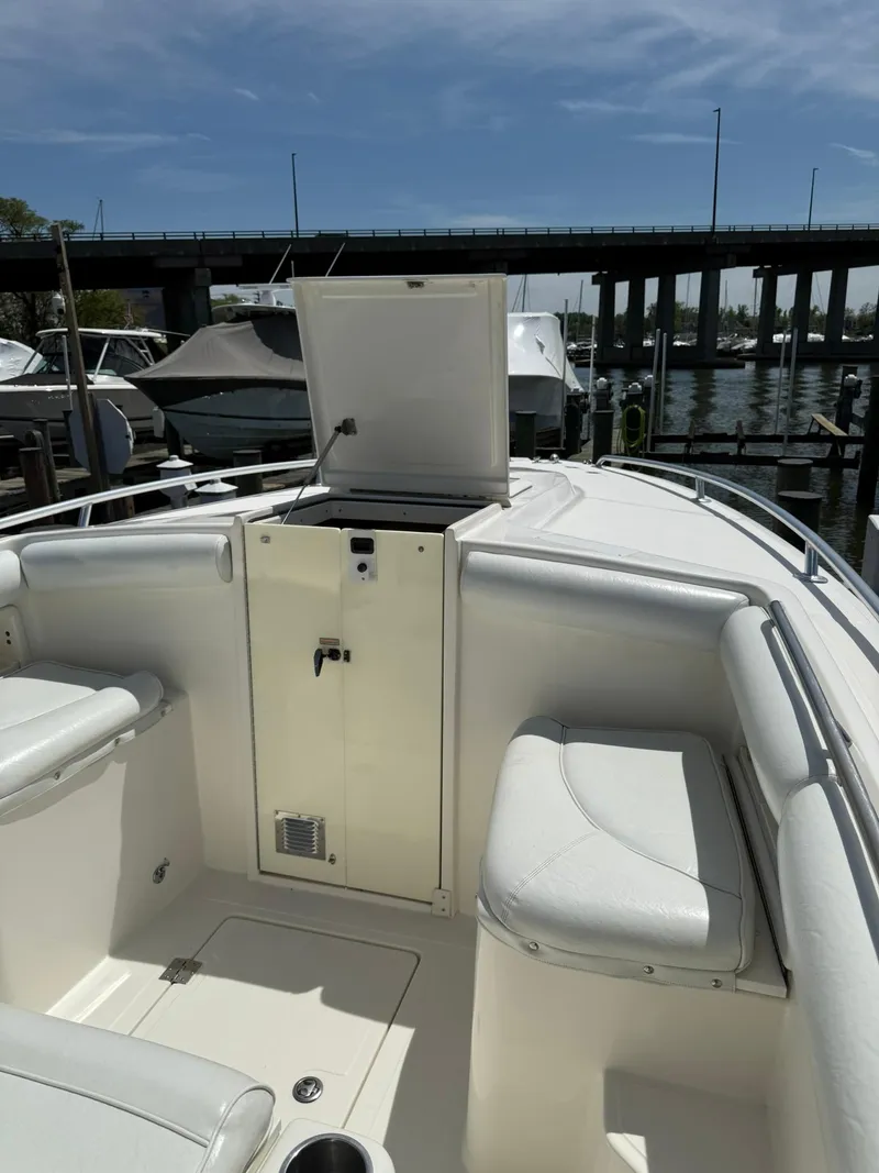 Slide: The Image of 2006 Marlago FS35 boat interior with open storage, docked near a bridge. - 13