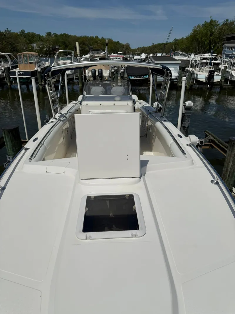 Slide: The Image of 2006 Marlago FS35 boat docked in a marina, showcasing sleek design and spacious deck. - 14