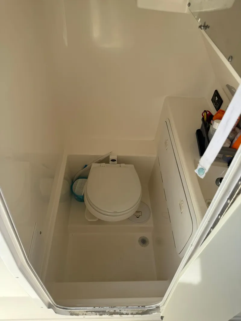 Slide: The Image of 2006 Marlago FS35 boat bathroom with toilet and storage compartments. - 16