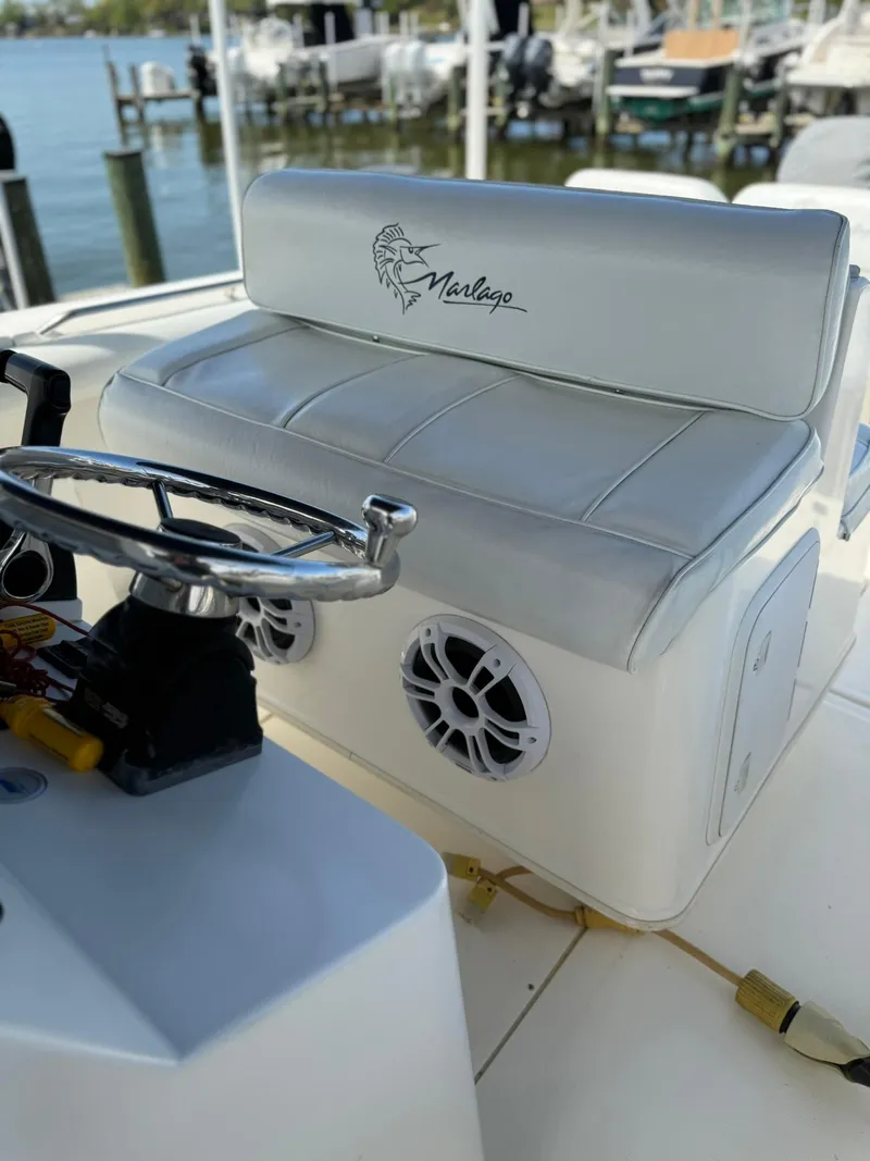 Slide: The Image of 2006 Marlago FS35 boat interior with steering wheel and cushioned seating. - 17