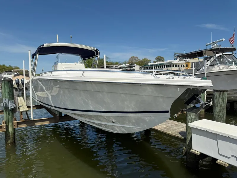 Slide: The Image of 2006 Marlago FS35 boat docked at marina under clear blue sky. - 2