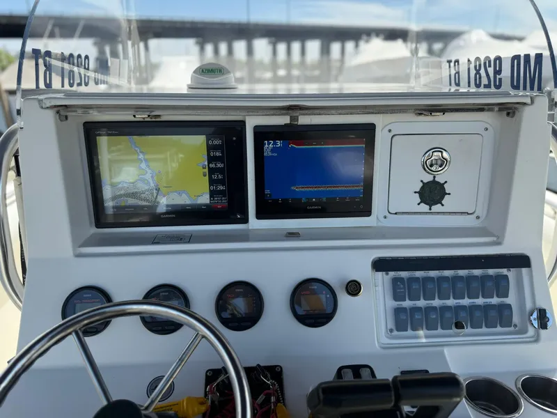 Slide: The Image of Dashboard of a 2006 Marlago FS35 boat with navigation screens and controls. - 20