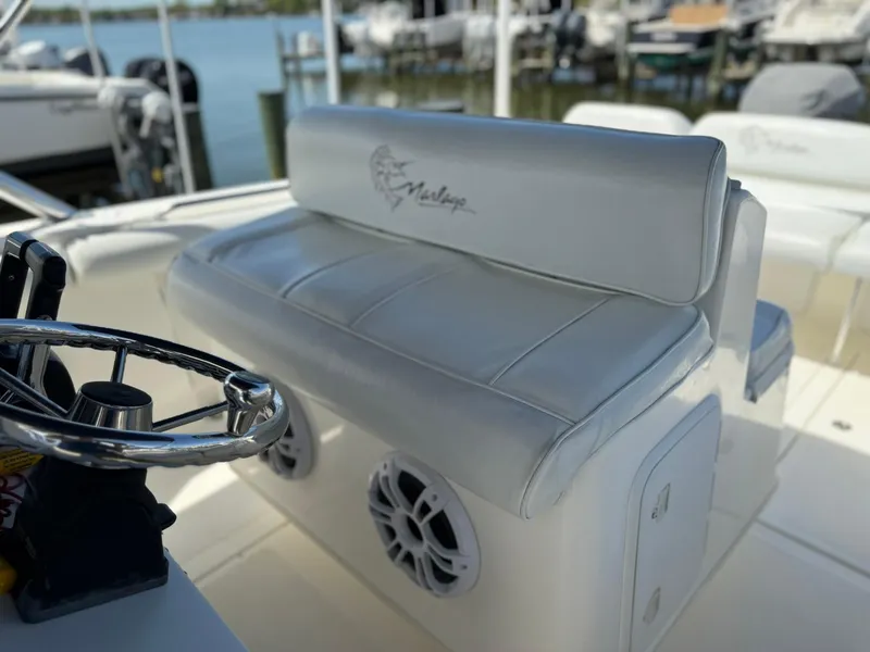 Slide: The Image of 2006 Marlago FS35 boat interior with white seating and steering wheel. - 22