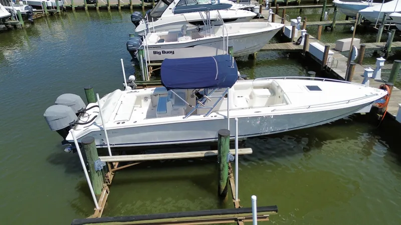 Slide: The Image of 2006 Marlago FS35 boat docked in marina with twin outboard engines. - 4