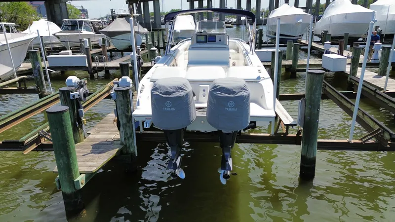 Slide: The Image of 2006 Marlago FS35 boat docked with twin engines, covered, in a marina setting. - 6