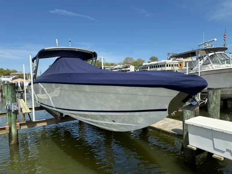 Slide: The Image of 2006 Marlago FS35 boat with cover, docked in a marina under clear blue sky. - 8