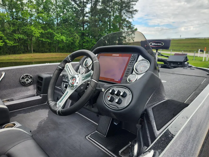Slide: The Image of 2021 Triton 20 TRX boat dashboard with steering wheel and navigation display. - 10