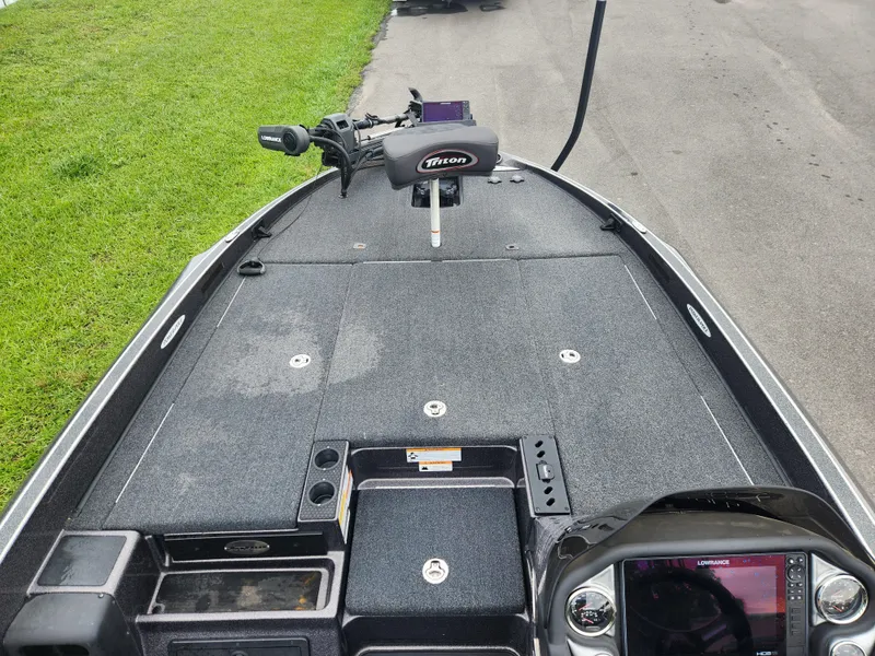 Slide: The Image of 2021 Triton 20 TRX boat deck with control panel and trolling motor. - 13