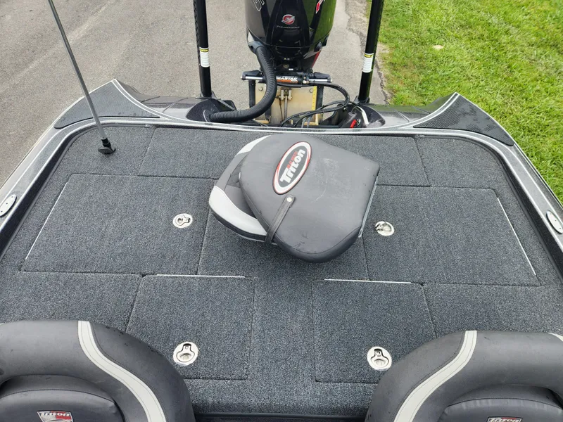 Slide: The Image of 2021 Triton 20 TRX boat deck with seating and storage compartments. - 14