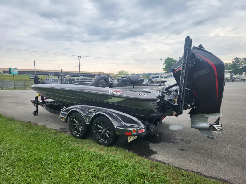 Slide: The Image of 2021 Triton 20 TRX boat on trailer, parked outdoors under cloudy sky. - 4