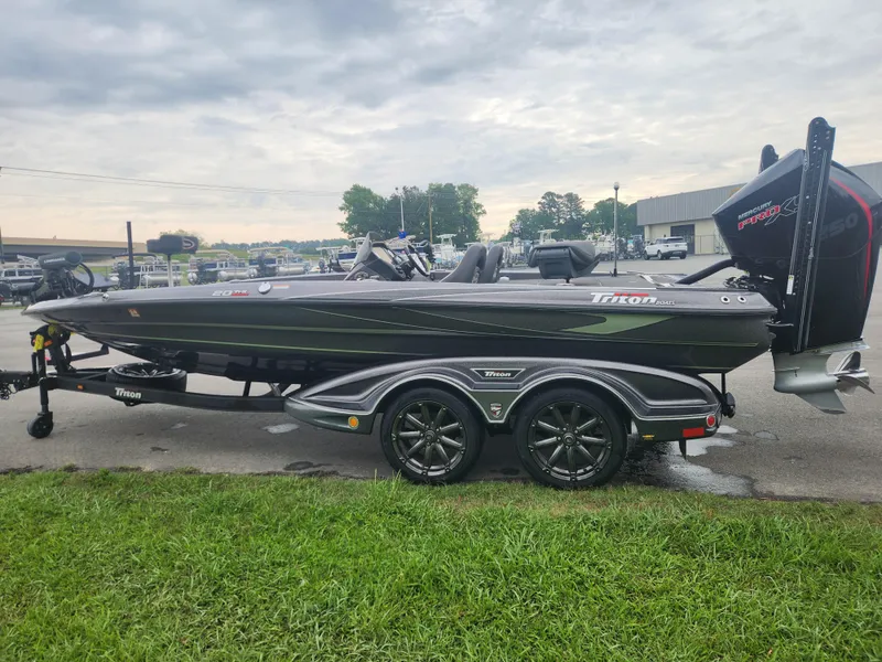 Slide: The Image of 2021 Triton 20 TRX boat on trailer, parked outdoors on a cloudy day. - 5