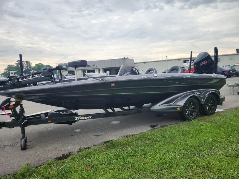 Slide: The Image of 2021 Triton 20 TRX boat on trailer, parked outdoors under cloudy sky. - 6