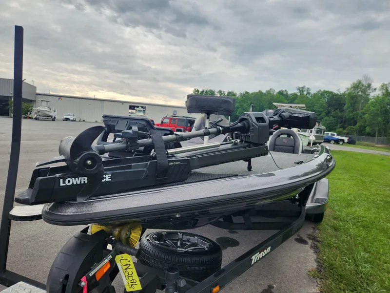 Slide: The Image of 2021 Triton 20 TRX boat on trailer with Lowrance equipment, parked outdoors. - 7