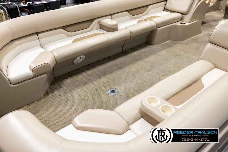 Slide: The Image of 2006 Sylvan 8524 Mirage RE boat interior with beige seating and carpeted floor. - 10