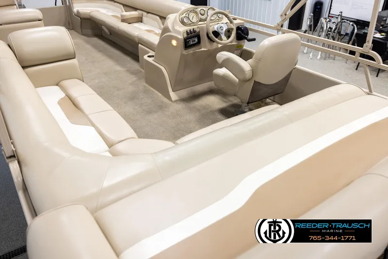 Slide: The Image of 2006 Sylvan 8524 Mirage RE pontoon boat interior with beige seating and steering console. - 11