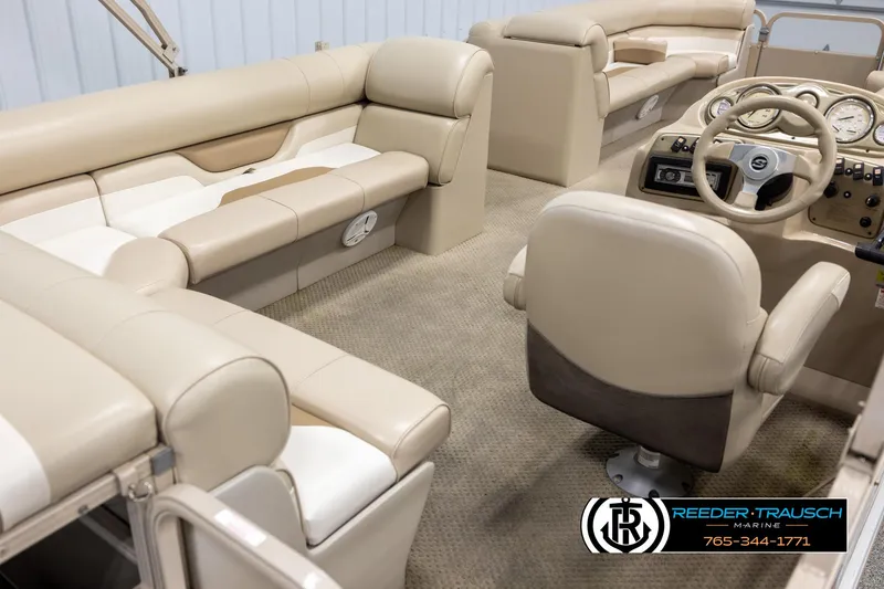 Slide: The Image of 2006 Sylvan 8524 Mirage RE pontoon boat interior with beige seating and steering console. - 12