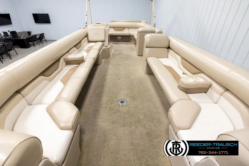 Slide: The Image of 2006 Sylvan 8524 Mirage RE pontoon boat interior with beige seating and carpet. - 13