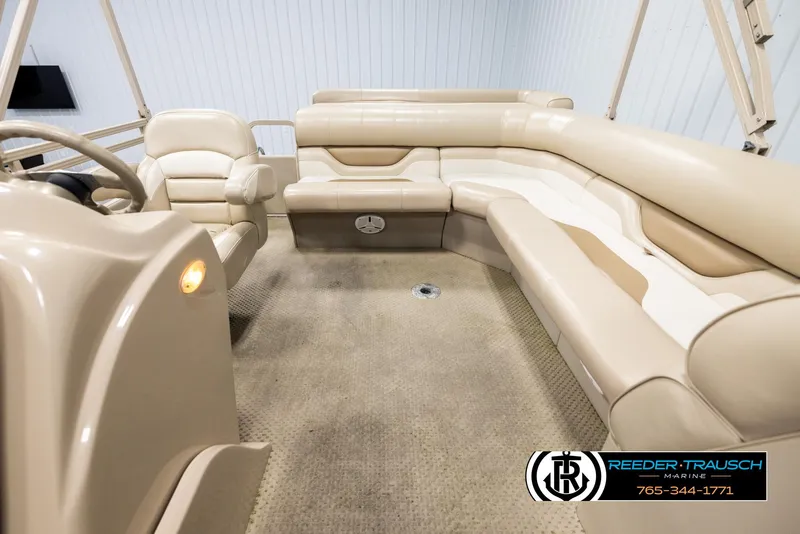 Slide: The Image of 2006 Sylvan 8524 Mirage RE boat interior with beige seating and carpet. - 14