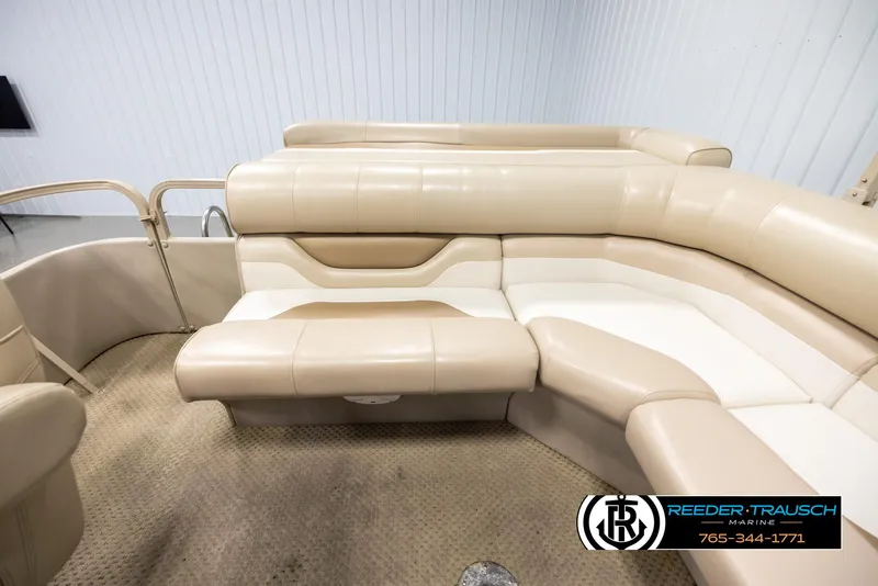 Slide: The Image of 2006 Sylvan 8524 Mirage RE boat interior with beige seating and carpet flooring. - 15