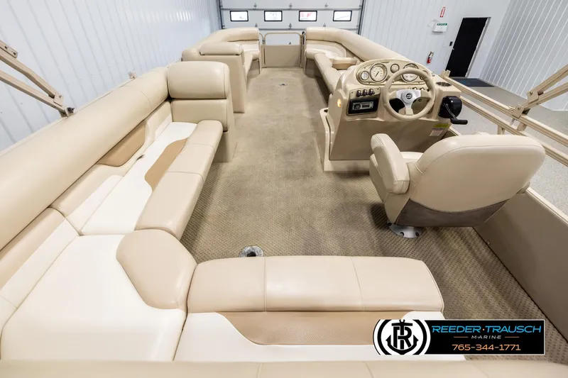 Slide: The Image of 2006 Sylvan 8524 Mirage RE pontoon boat interior with beige seating and steering console. - 16