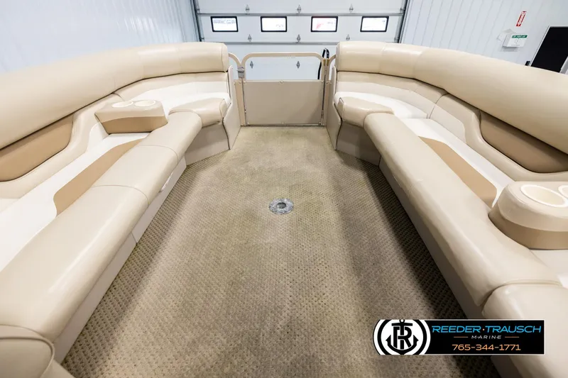 Slide: The Image of 2006 Sylvan 8524 Mirage RE boat interior with beige seating and carpet flooring. - 18