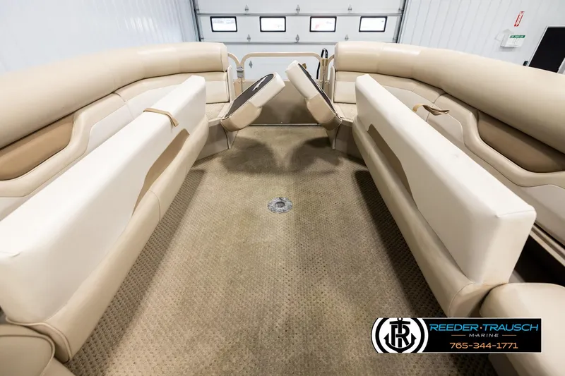 Slide: The Image of 2006 Sylvan 8524 Mirage RE interior with beige seating and carpet flooring. - 19