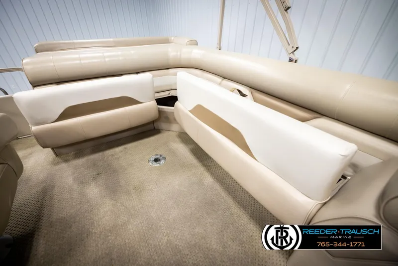 Slide: The Image of 2006 Sylvan 8524 Mirage RE boat interior with beige seating and carpet. - 21