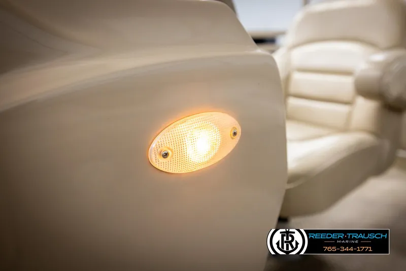 Slide: The Image of 2006 Sylvan 8524 Mirage RE interior with illuminated side light and plush seating. - 28