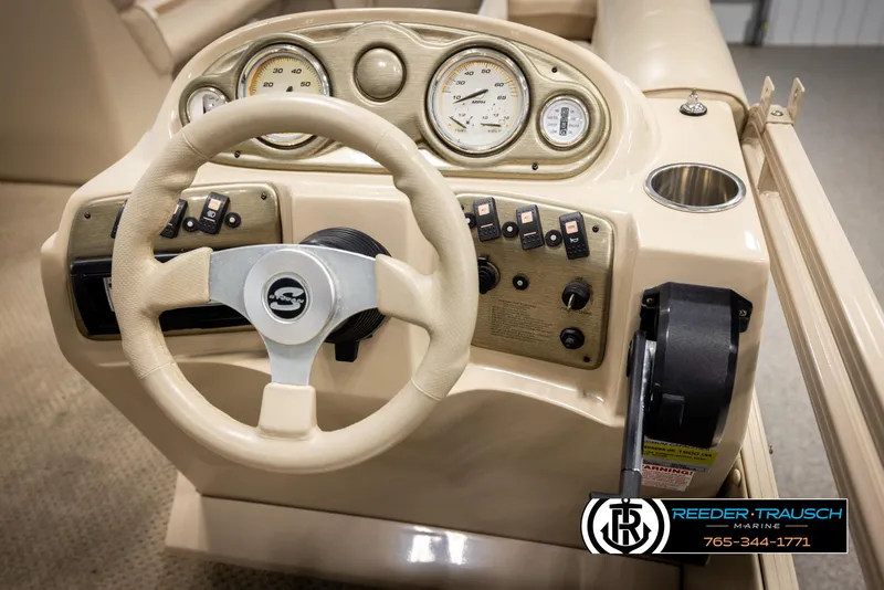 Slide: The Image of 2006 Sylvan 8524 Mirage RE boat dashboard with steering wheel and controls. - 29