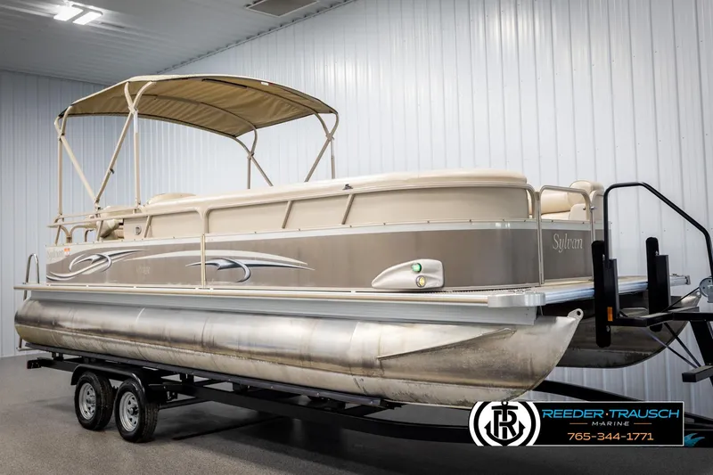 Slide: The Image of 2006 Sylvan 8524 Mirage RE pontoon boat on trailer in indoor storage. - 3