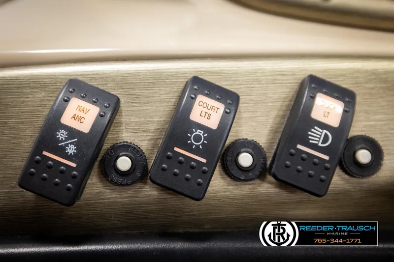 Slide: The Image of Control panel switches on a 2006 Sylvan 8524 Mirage RE boat dashboard. - 33