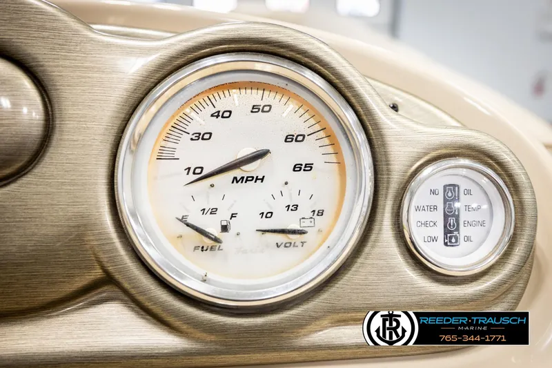 Slide: The Image of Dashboard of 2006 Sylvan 8524 Mirage RE with speedometer and fuel gauge. - 35