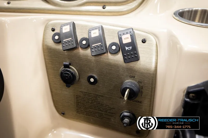 Slide: The Image of Control panel of a 2006 Sylvan 8524 Mirage RE boat with switches and ignition. - 36