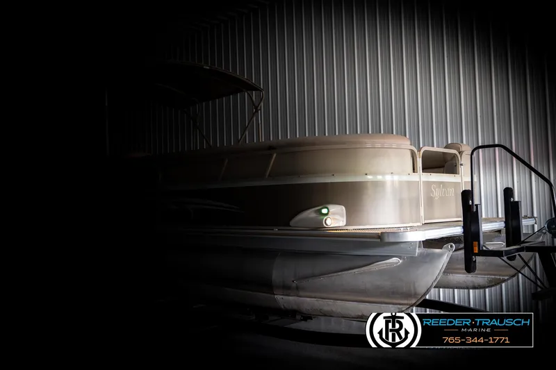 Slide: The Image of 2006 Sylvan 8524 Mirage RE pontoon boat in dimly lit storage. - 4