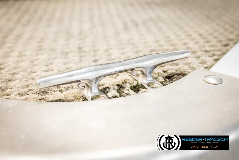 Slide: The Image of Close-up of a 2006 Sylvan 8524 Mirage RE boat cleat on textured surface. - 45