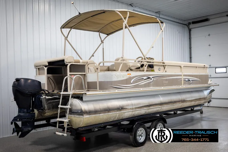 Slide: The Image of 2006 Sylvan 8524 Mirage RE pontoon boat on trailer in indoor storage. - 6