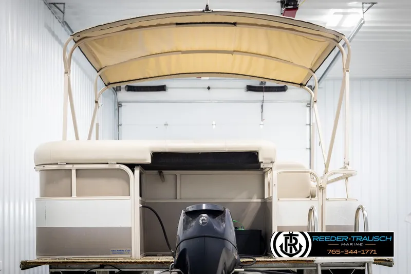 Slide: The Image of 2006 Sylvan 8524 Mirage RE pontoon boat with canopy in a storage facility. - 7
