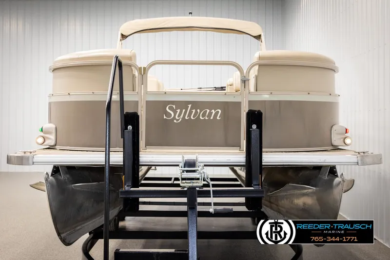 Slide: The Image of 2006 Sylvan 8524 Mirage RE pontoon boat on trailer in indoor storage. - 8
