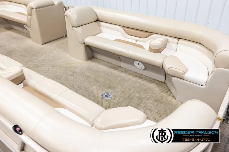 Slide: The Image of 2006 Sylvan 8524 Mirage RE boat interior with beige seating and carpet. - 9