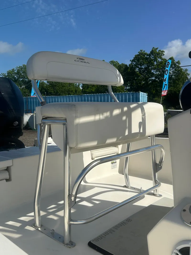 Slide: The Image of 2021 Cobia 21 Bay boat seat with stainless steel frame under clear blue sky. - 11