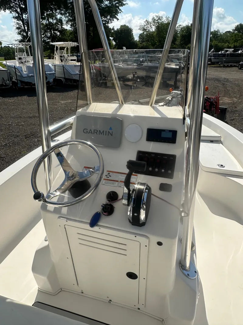 Slide: The Image of 2021 Cobia 21 Bay boat console with Garmin navigation system and steering wheel. - 18