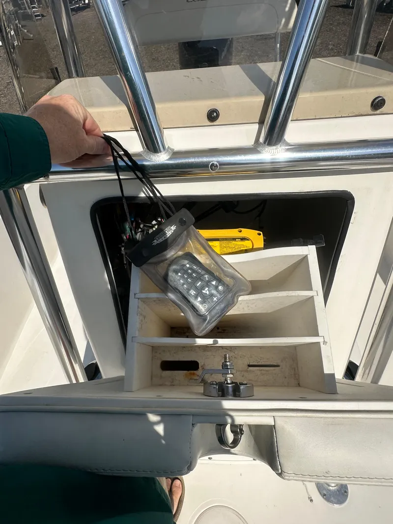 Slide: The Image of 2021 Cobia 21 Bay boat console with storage compartments and handheld light. - 23