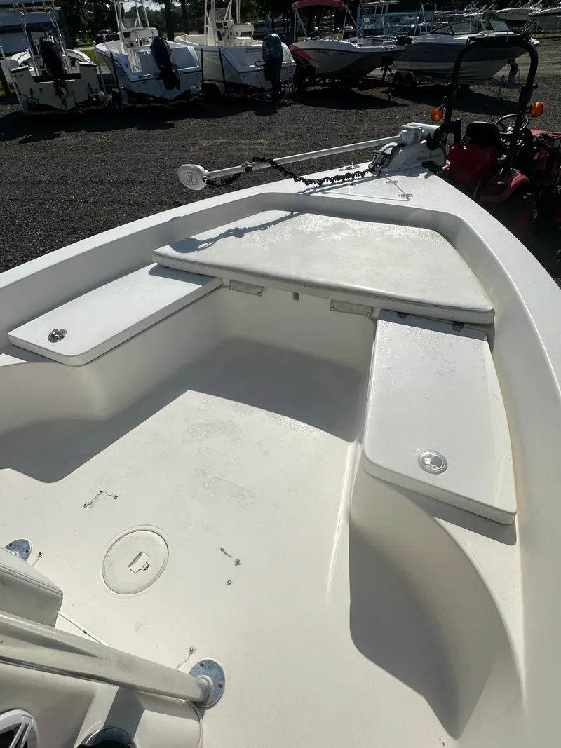 Slide: The Image of 2021 Cobia 21 Bay boat interior with seating and storage compartments. - 24