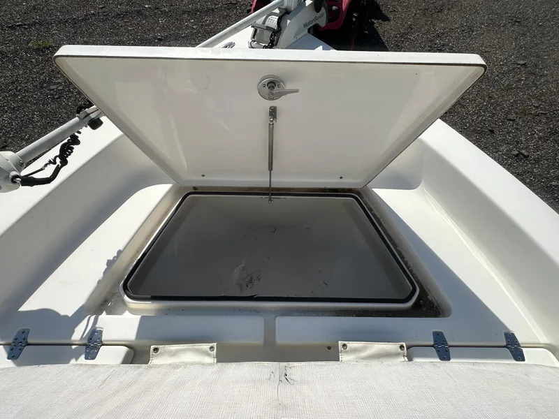 Slide: The Image of Open storage compartment on a 2021 Cobia 21 Bay boat, showcasing interior space. - 31