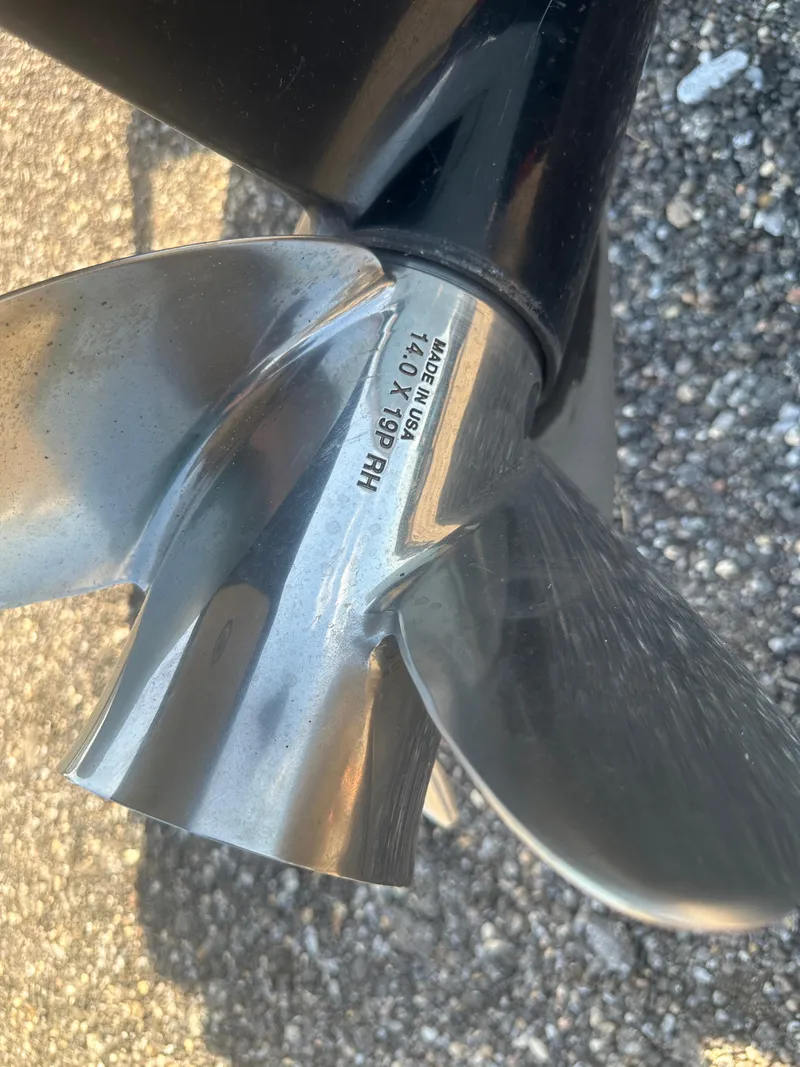 Slide: The Image of Close-up of a 2021 Cobia 21 Bay boat propeller on a textured surface. - 33