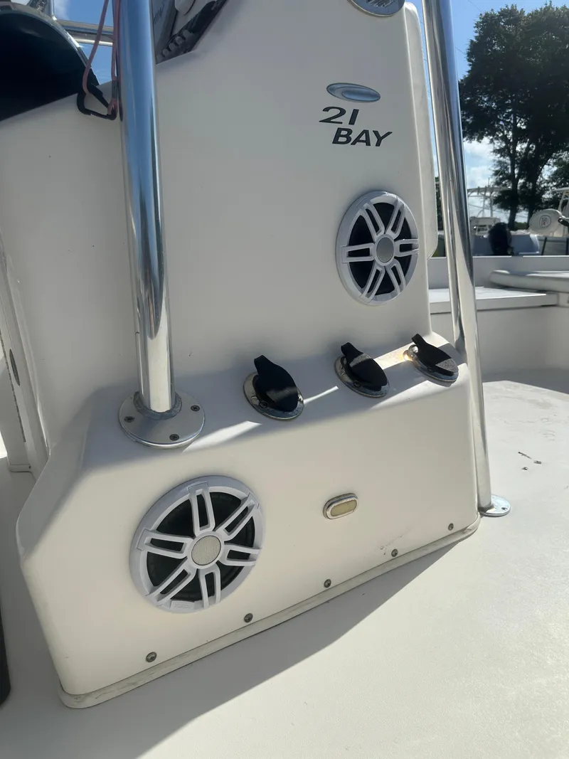 Slide: The Image of 2021 Cobia 21 Bay boat console with speakers and controls, sunny day. - 34