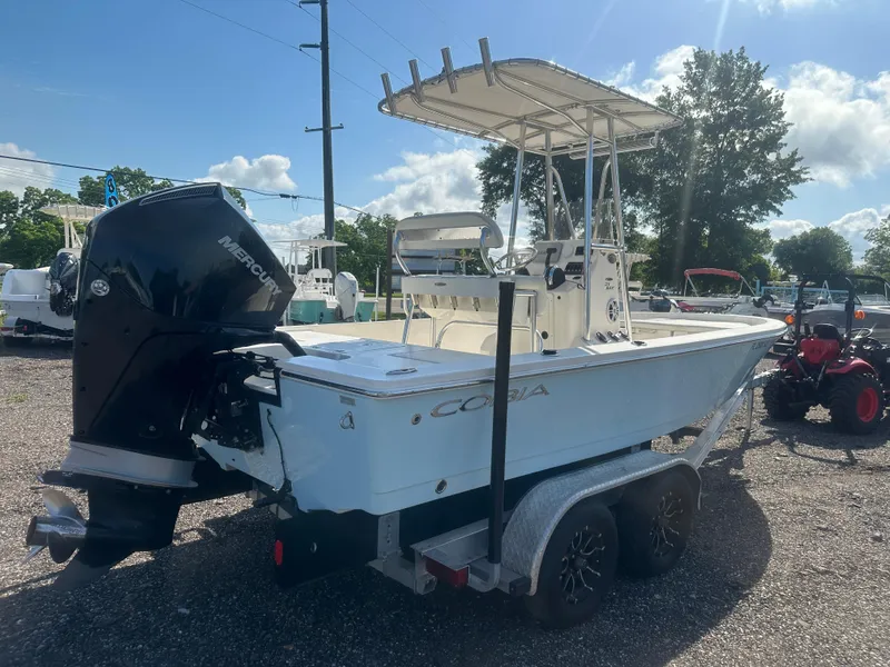 Slide: The Image of 2021 Cobia 21 Bay boat on trailer, featuring a Mercury outboard motor. - 6