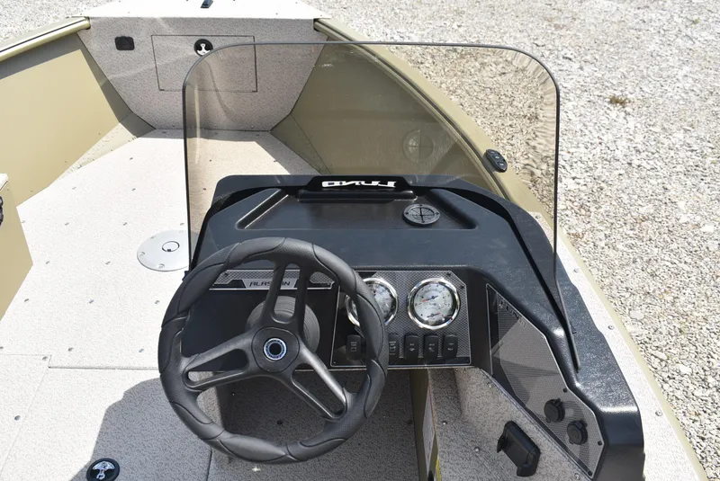 Slide: The Image of 2025 Lund 1875 Alaskan SS boat dashboard with steering wheel and gauges. - 10