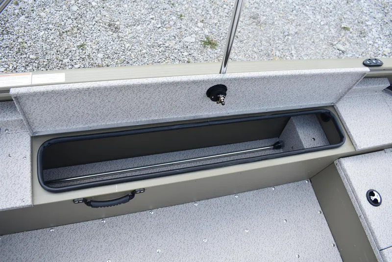 Slide: The Image of 2025 Lund 1875 Alaskan SS boat storage compartment with textured interior and handle. - 12