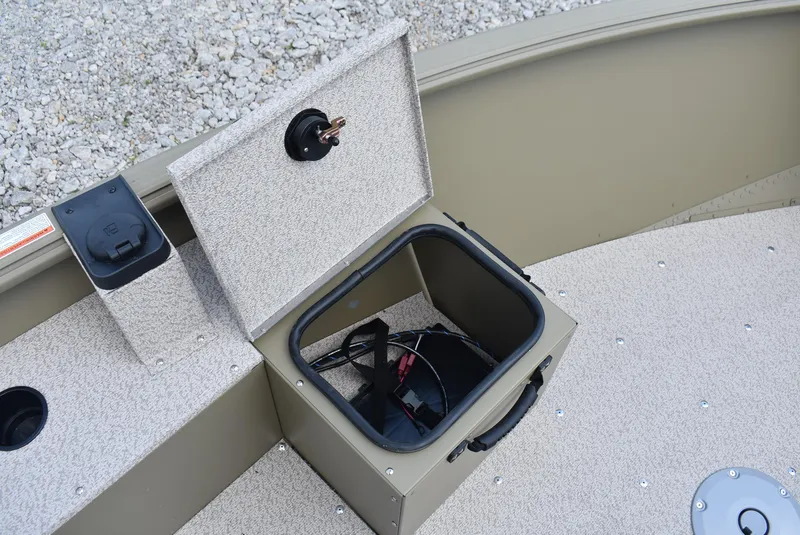 Slide: The Image of 2025 Lund 1875 Alaskan SS boat storage compartment with open lid and visible wiring. - 19